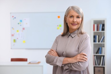 Portrait of happy professor in classroom, space for text