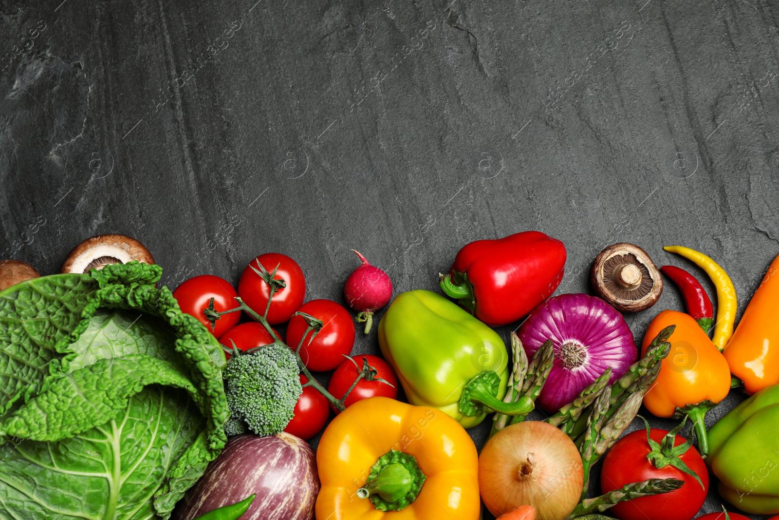 Photo of Flat lay composition with fresh vegetables on black table. Space for text