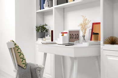 Photo of Cozy workspace with laptop on wooden desk at home