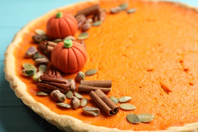 Photo of Delicious homemade pumpkin pie on light blue table, closeup