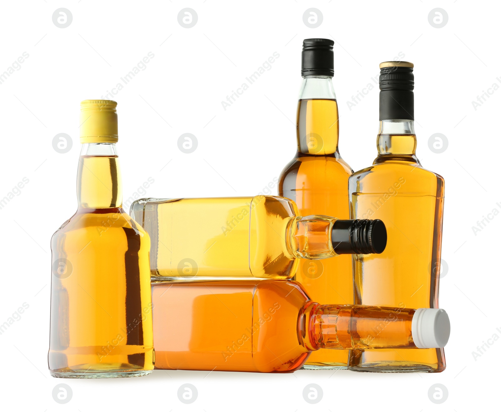 Photo of Different sorts of whiskey in glass bottles isolated on white