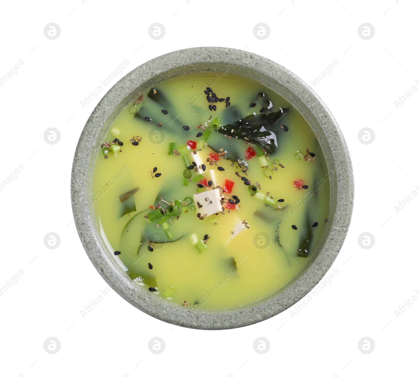 Photo of Bowl of delicious miso soup with tofu isolated on white, top view