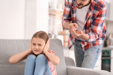 Father arguing with daughter at home