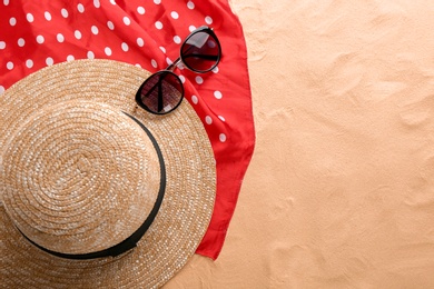 Photo of Flat lay composition with stylish hat and beach objects on sand