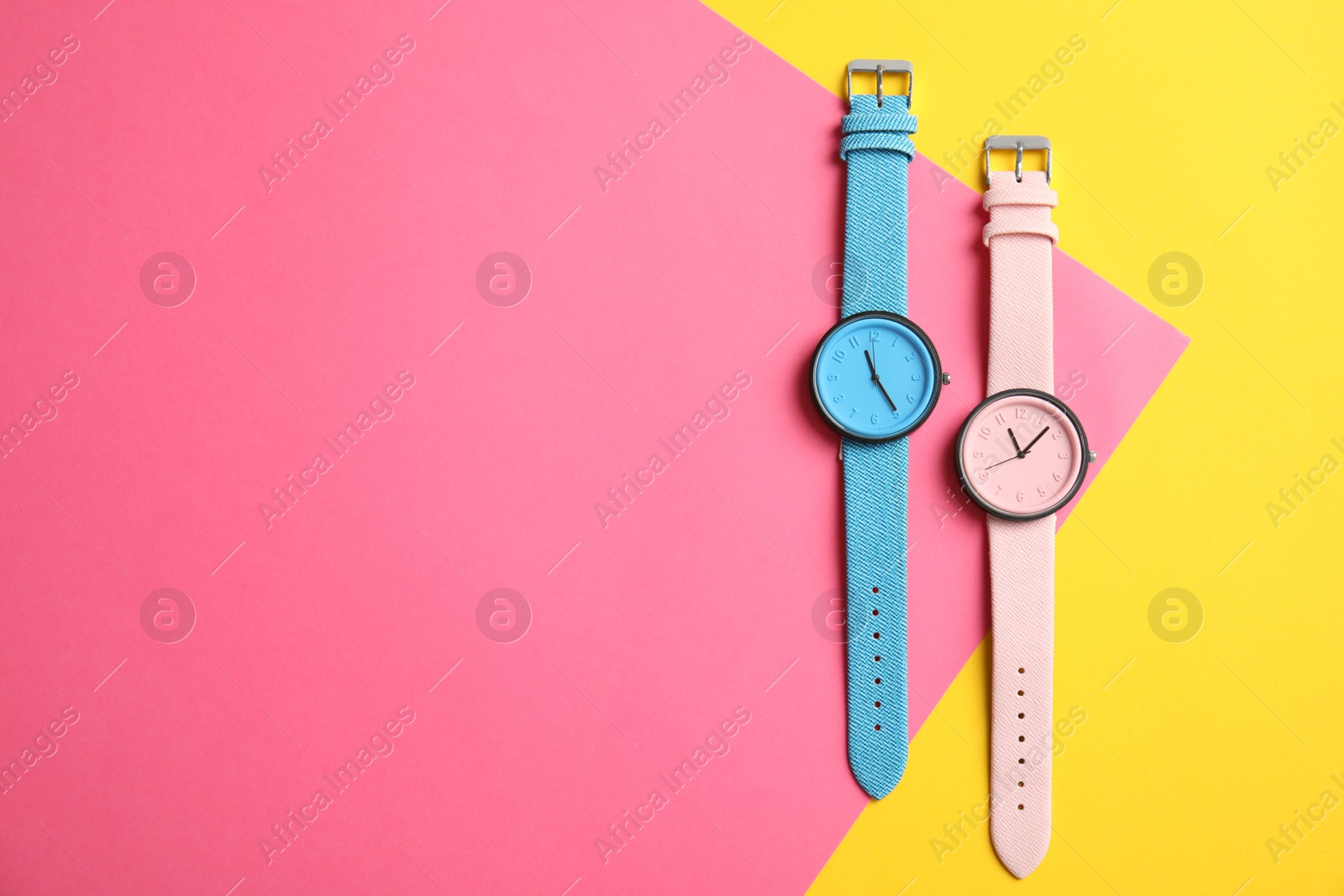 Photo of Flat lay composition with stylish wrist watches and space for text on color background. Fashion accessory
