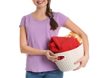 Photo of Young woman holding laundry basket with clothes on white background, closeup