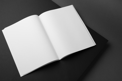 Photo of Empty book pages on dark background. Mockup for design