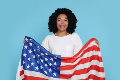 Photo of 4th of July - Independence Day of USA. Happy woman with American flag on light blue background