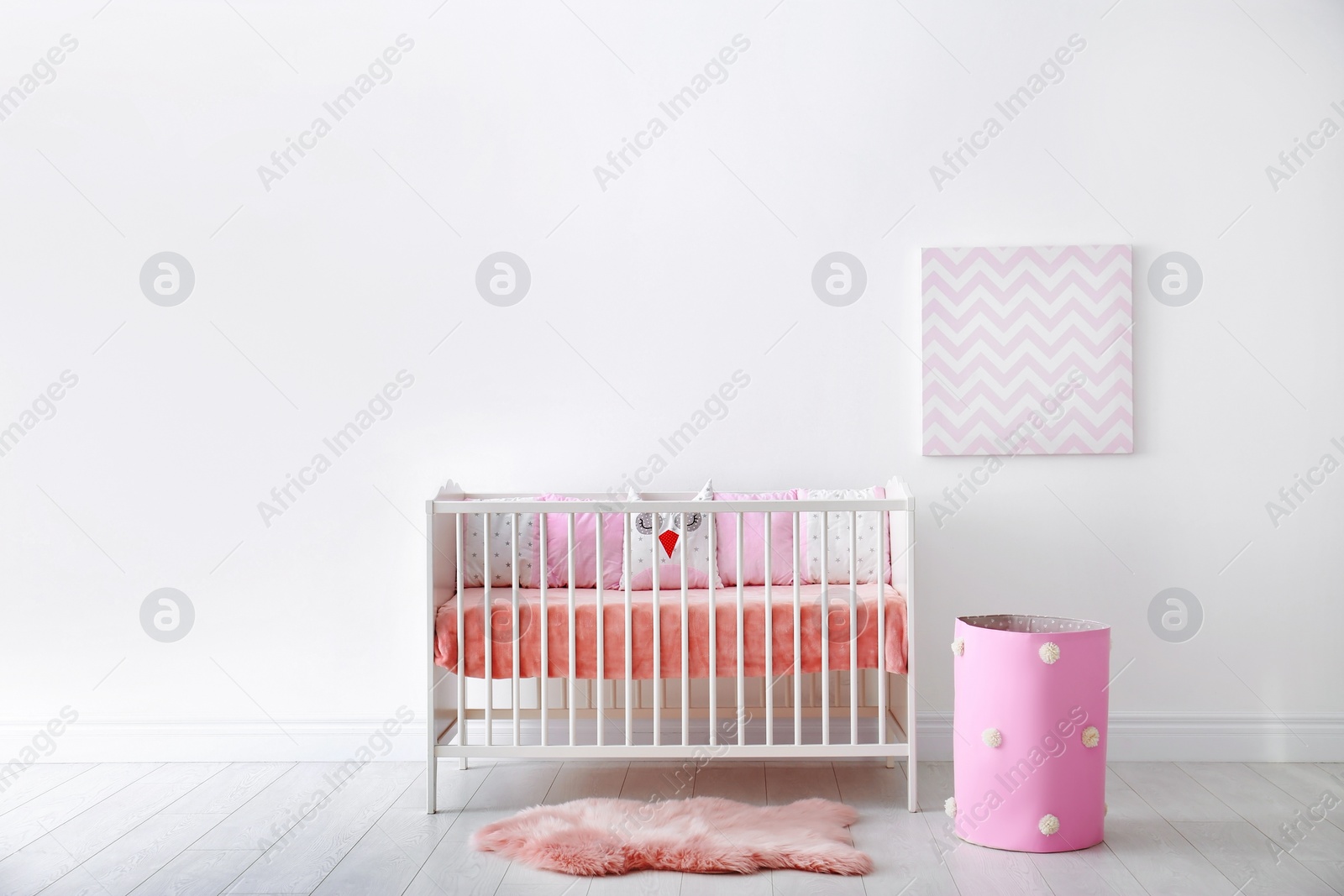 Photo of Baby room interior with crib near wall