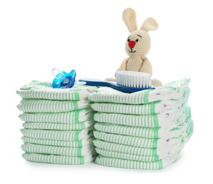 Photo of Disposable diapers and baby accessories on white background