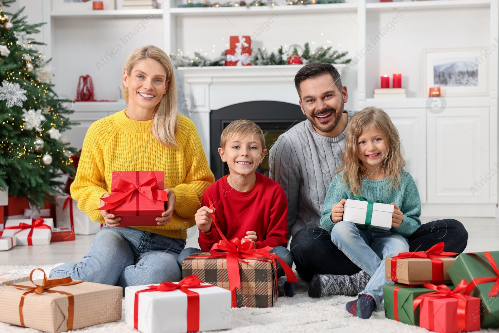 Photo of Happy family with Christmas gifts at home