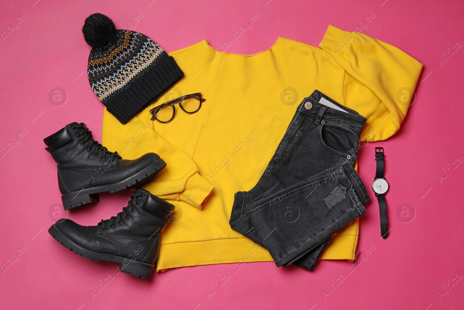 Photo of Flat lay composition with winter clothes and boots on pink background