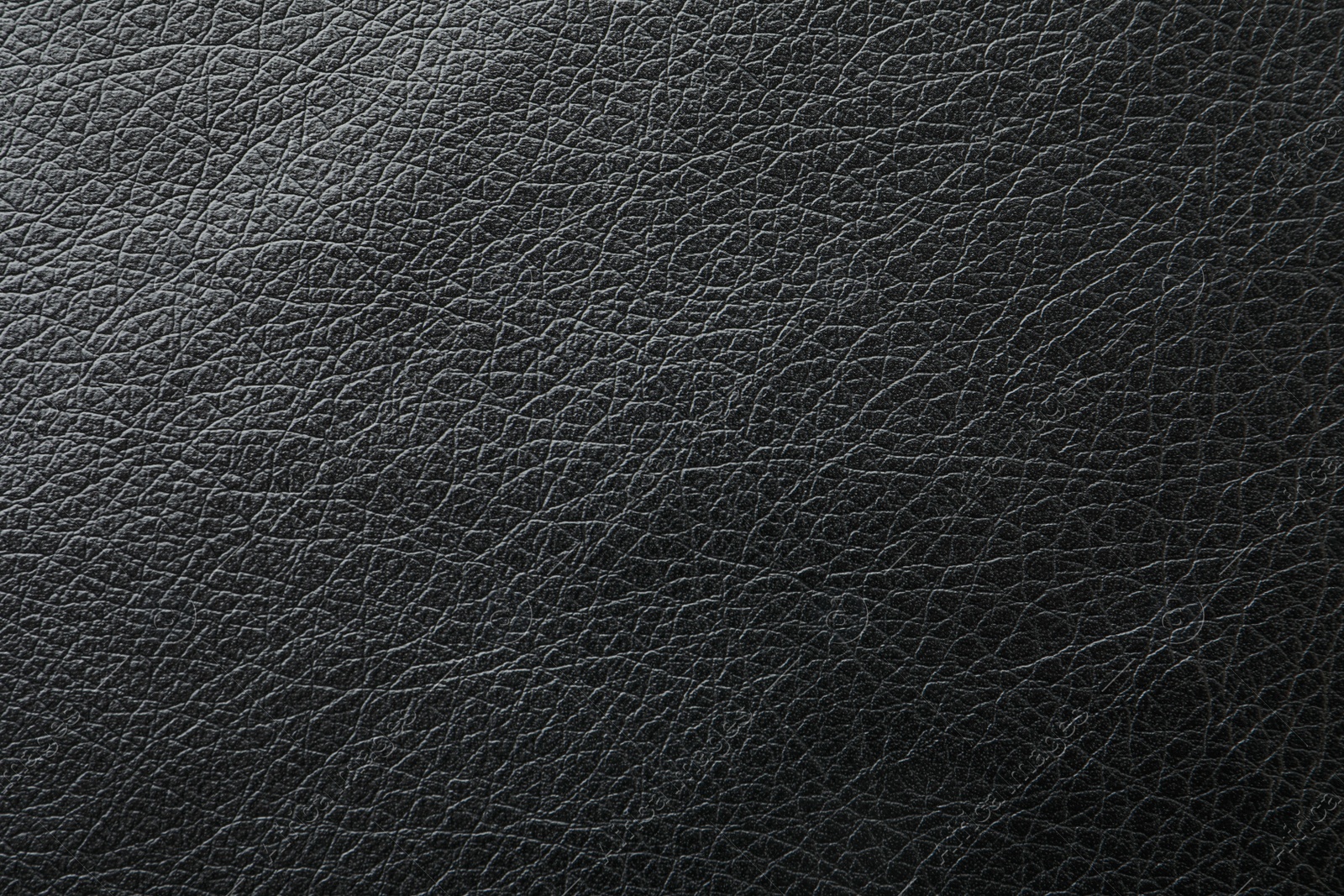 Photo of Texture of black leather as background, closeup