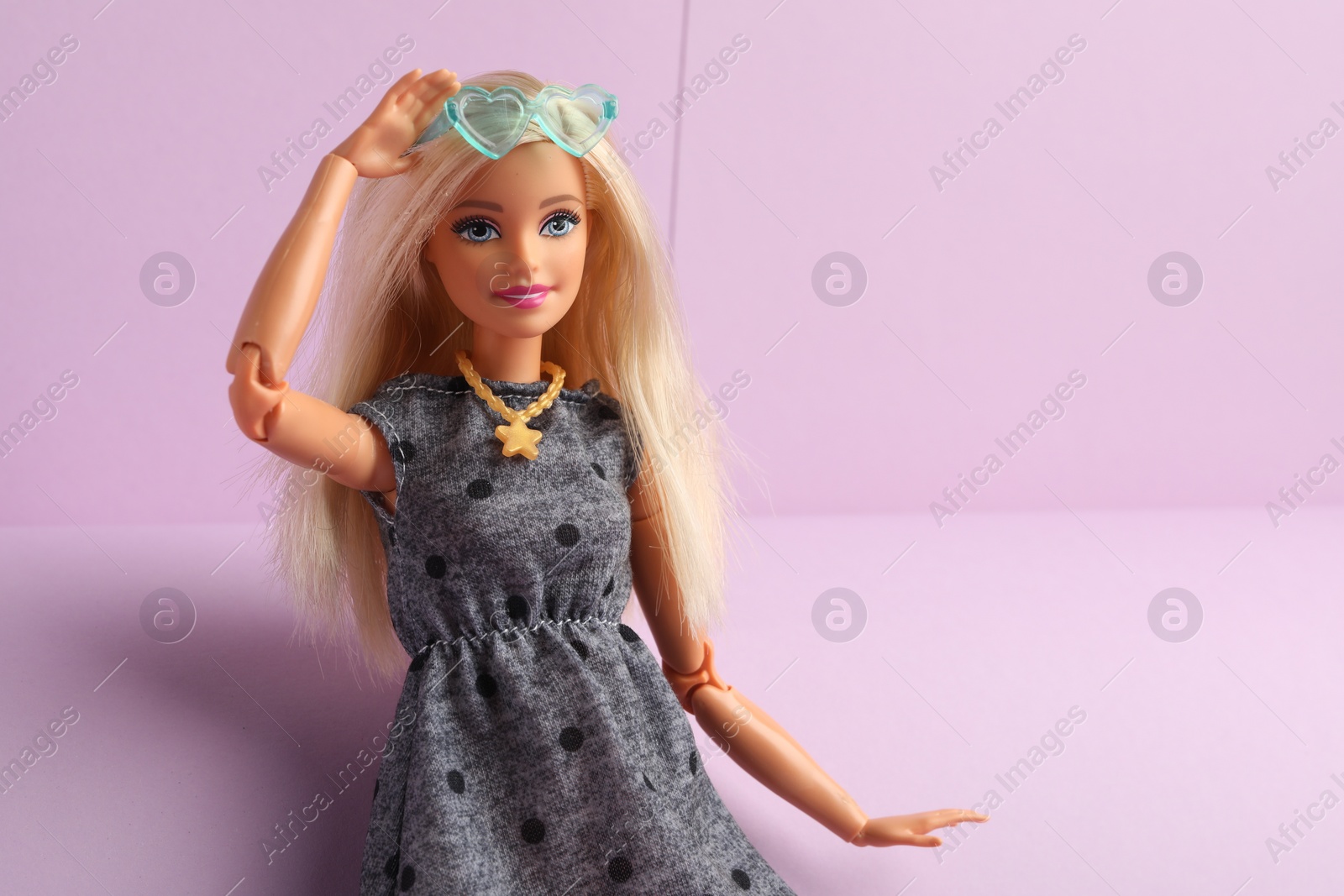 Photo of Mykolaiv, Ukraine - September 4, 2023: Beautiful Barbie doll with stylish eyeglasses on lilac background, space for text