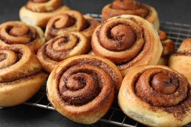 Photo of Tasty cinnamon rolls on table, closeup view