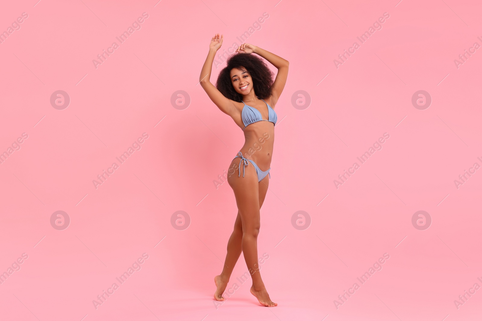Photo of Beautiful woman in stylish bikini posing on pink background