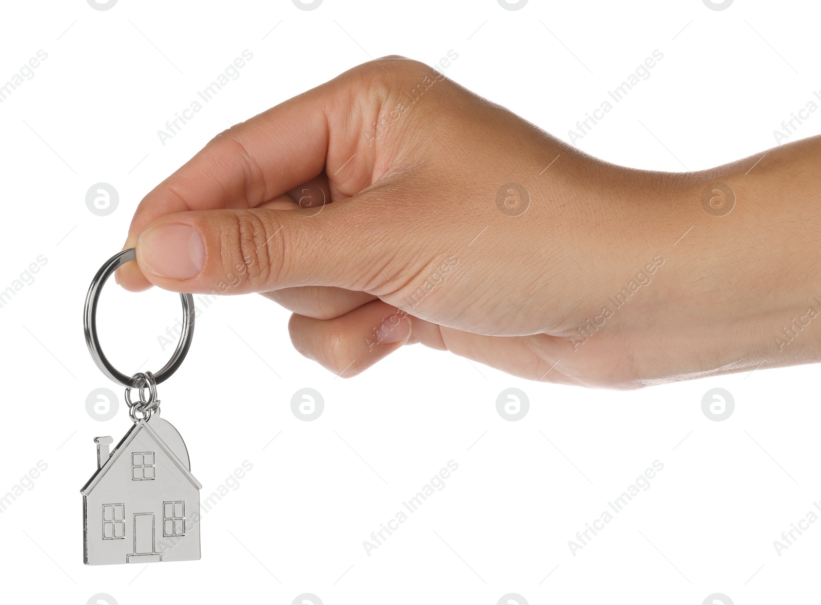 Photo of Woman holding metallic keychain in shape of house on white background, closeup