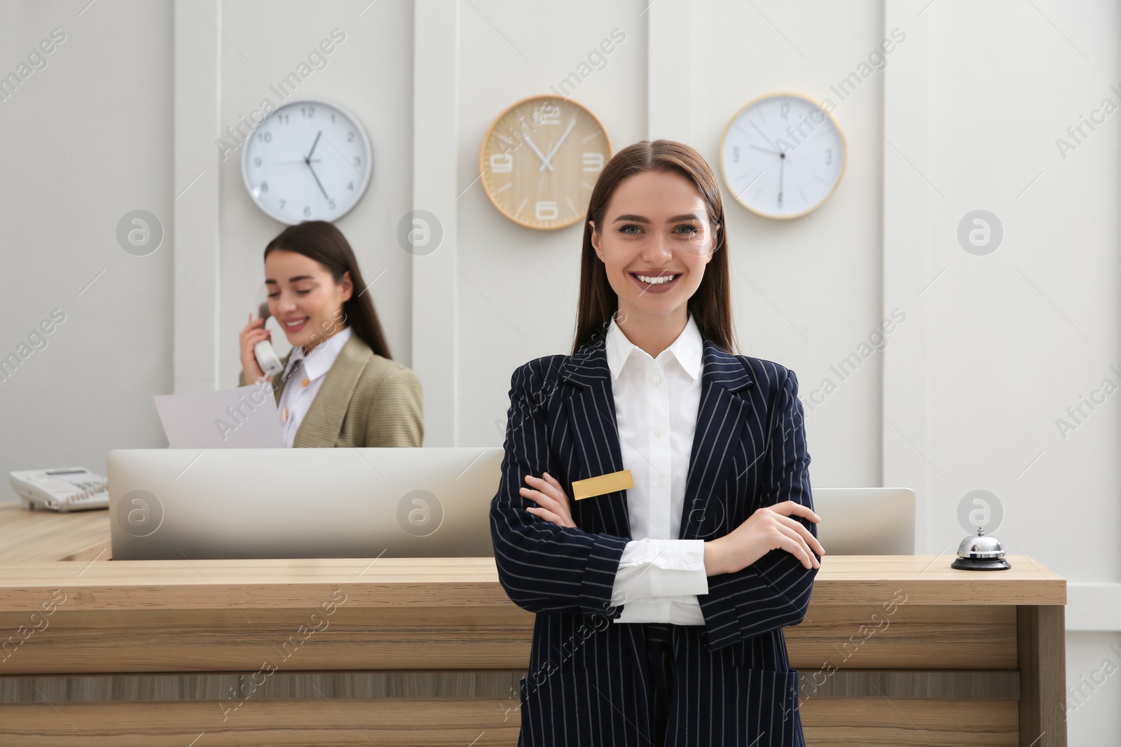 Photo of Portrait of beautiful receptionist near counter in hotel