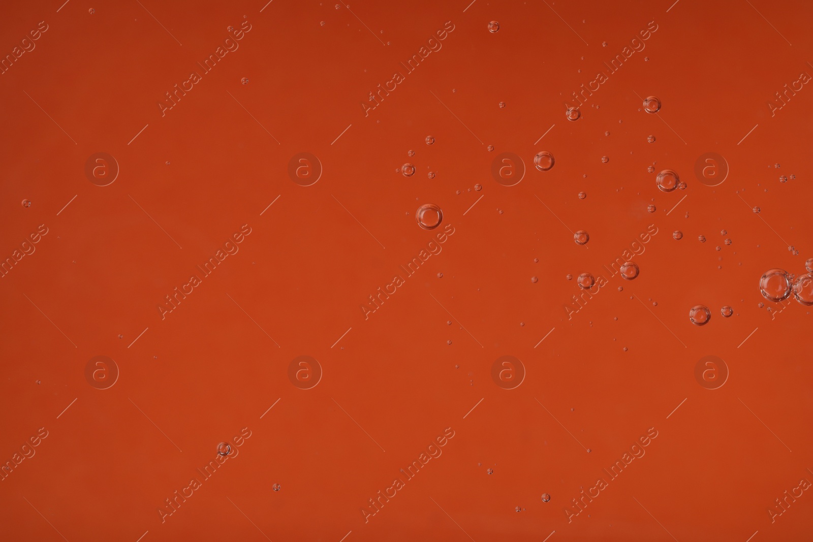 Photo of Pure transparent cosmetic gel on orange background, closeup