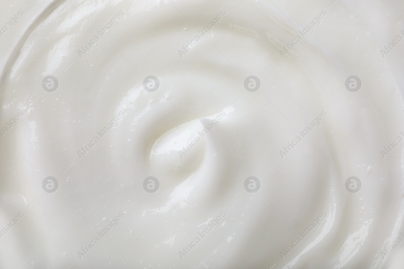 Photo of Texture of white body cream, closeup view