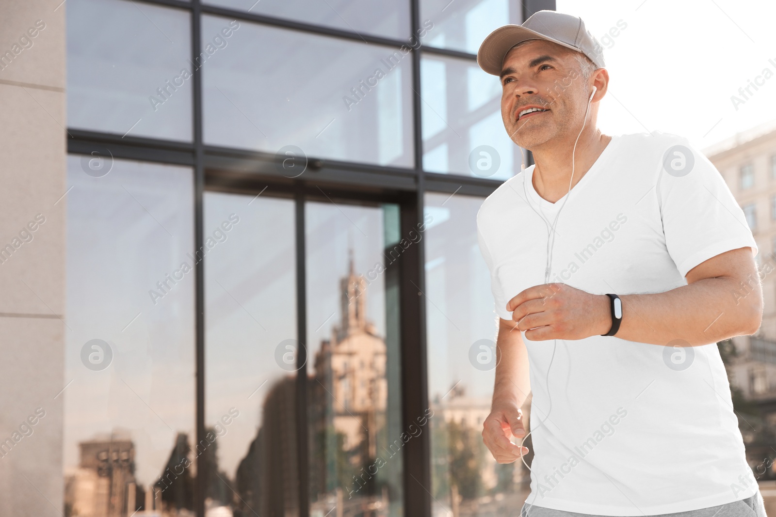 Photo of Handsome mature man running on street, space for text. Healthy lifestyle