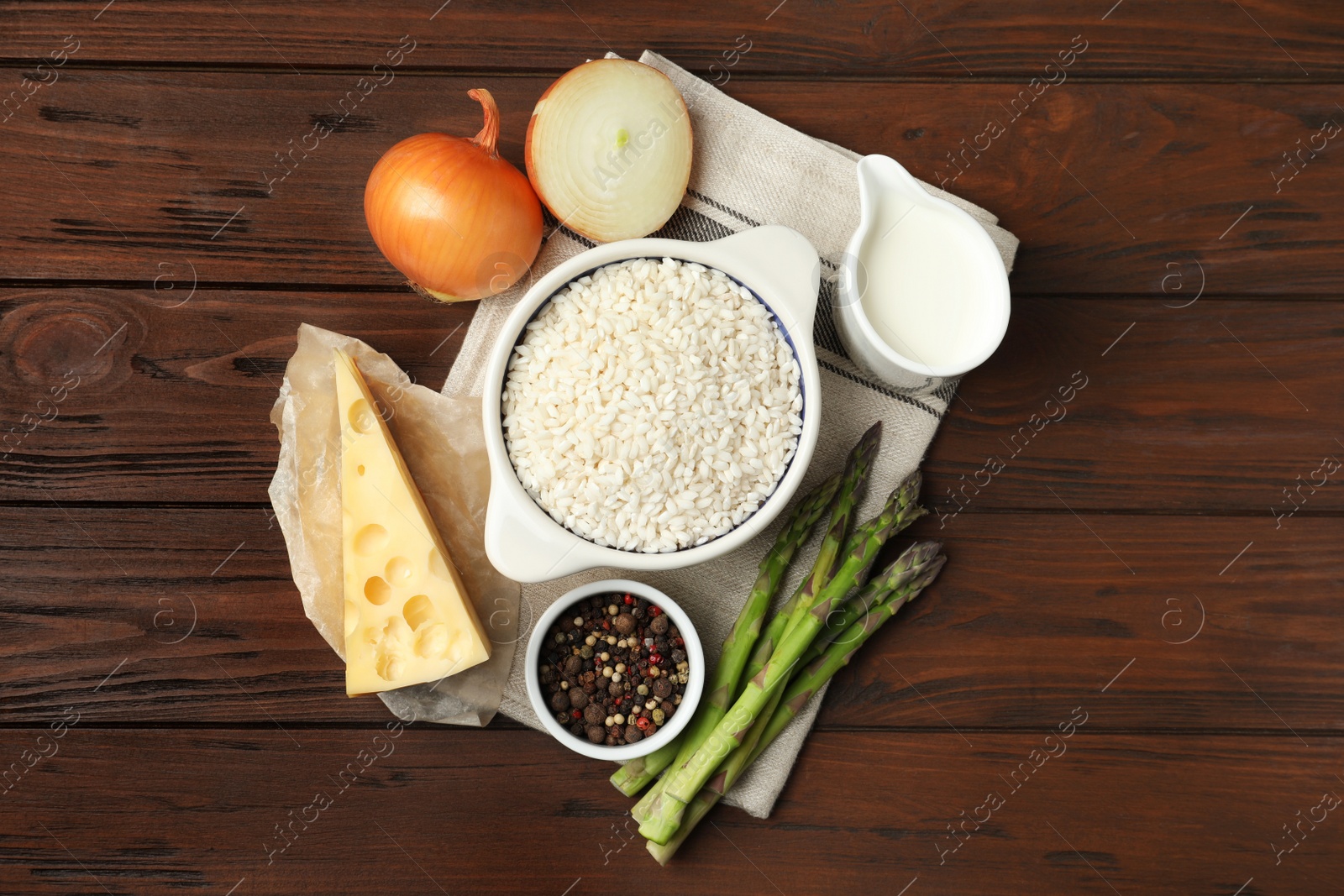 Photo of Flat lay composition with different ingredients on wooden table. Risotto recipe