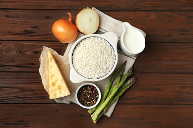 Photo of Flat lay composition with different ingredients on wooden table. Risotto recipe