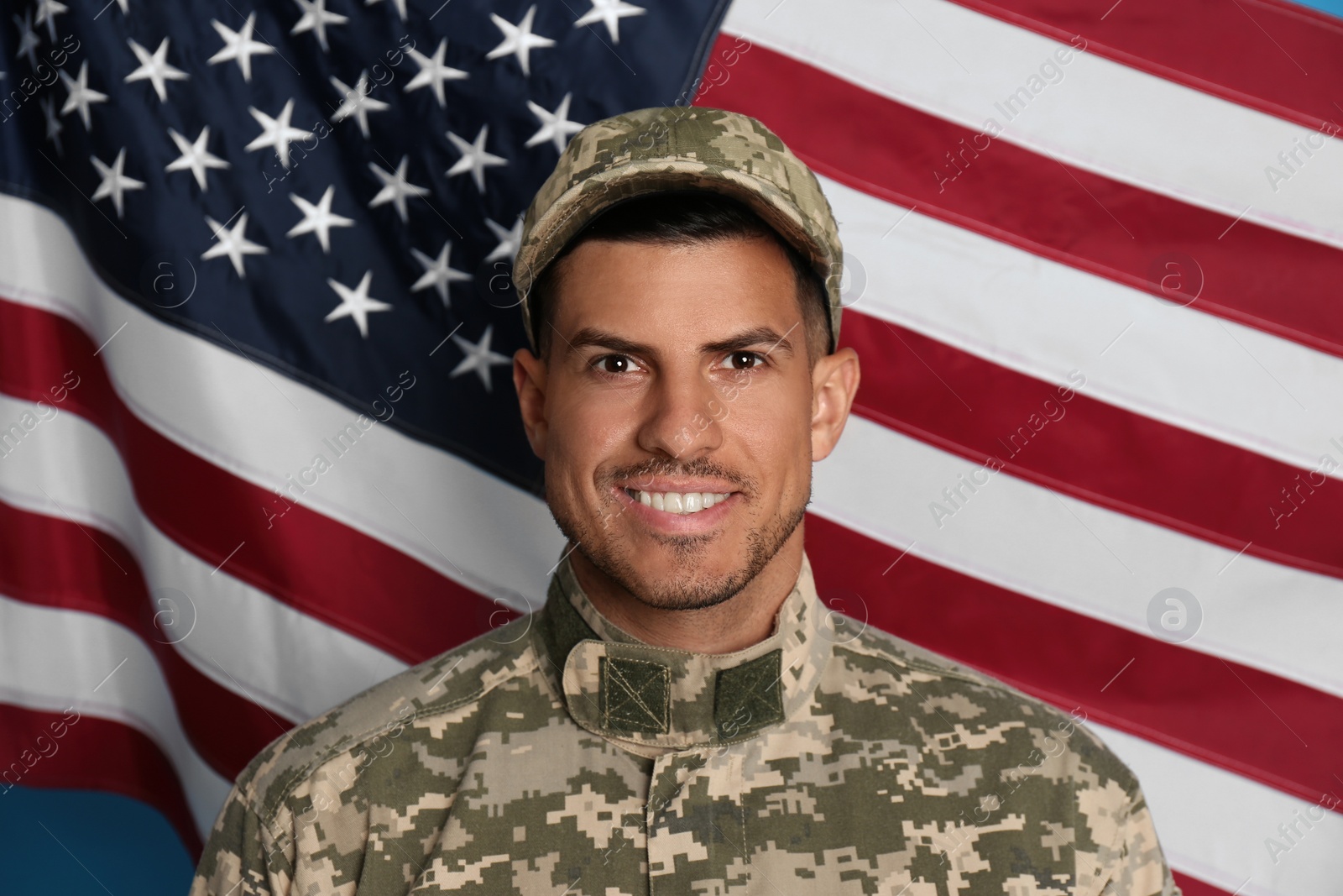 Photo of Soldier in uniform and United states of America flag on background