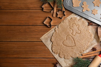 Homemade Christmas cookies. Flat lay composition with dough on wooden table, space for text