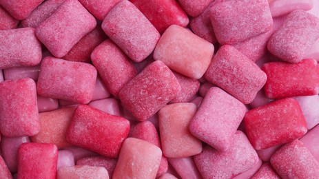 Many pink chewing gums as background, top view