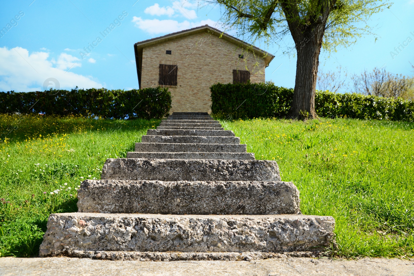 Photo of Stone stairs leading to house outdoors on sunny day