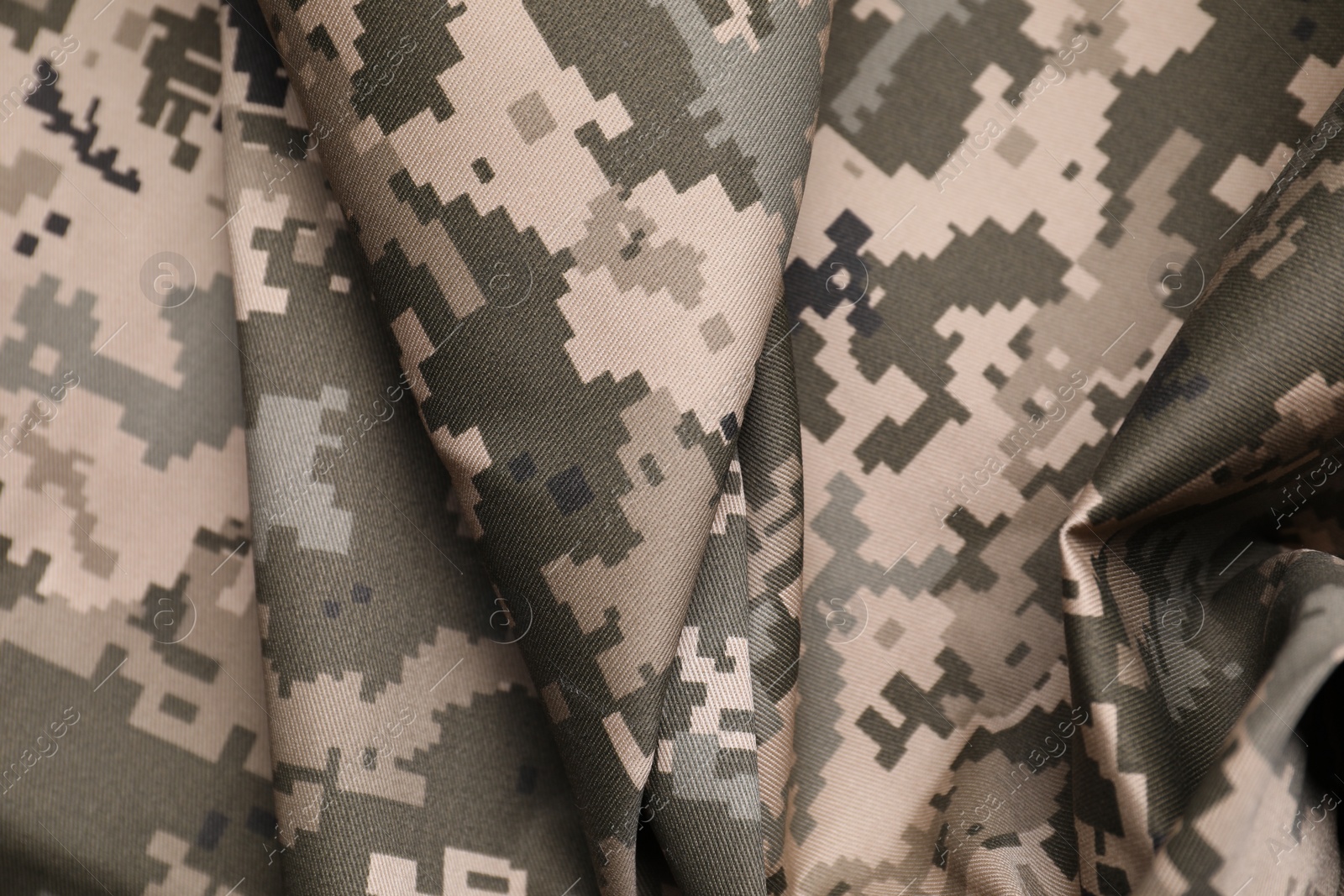 Photo of Texture of crumpled camouflage fabric as background, top view