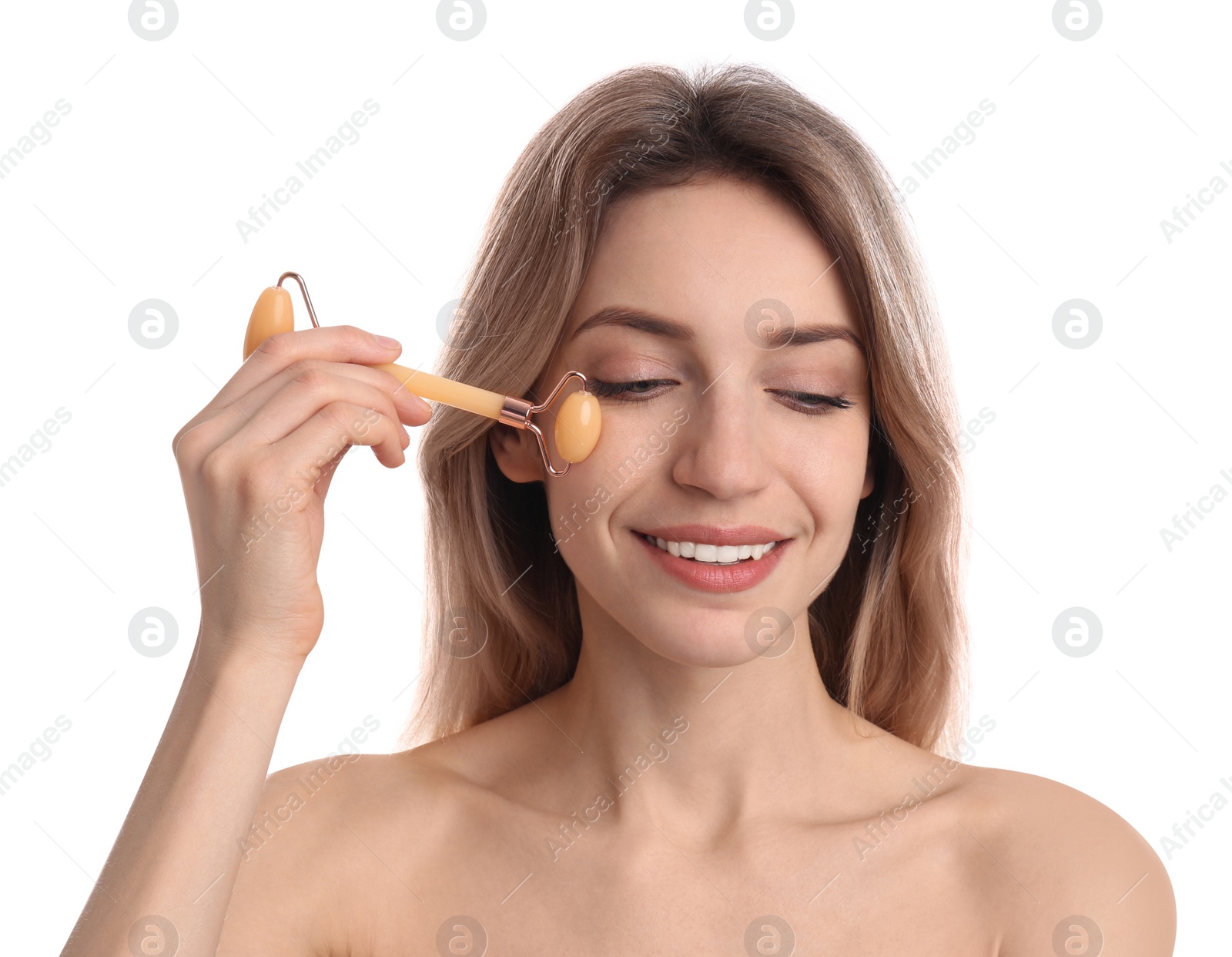 Photo of Young woman using natural jade face roller on white background