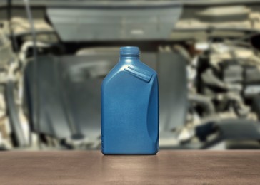 Image of Motor oil in blue container on grey table