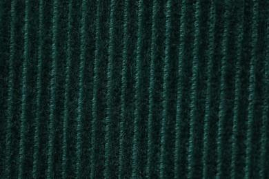 Texture of soft dark green knitted fabric as background, top view