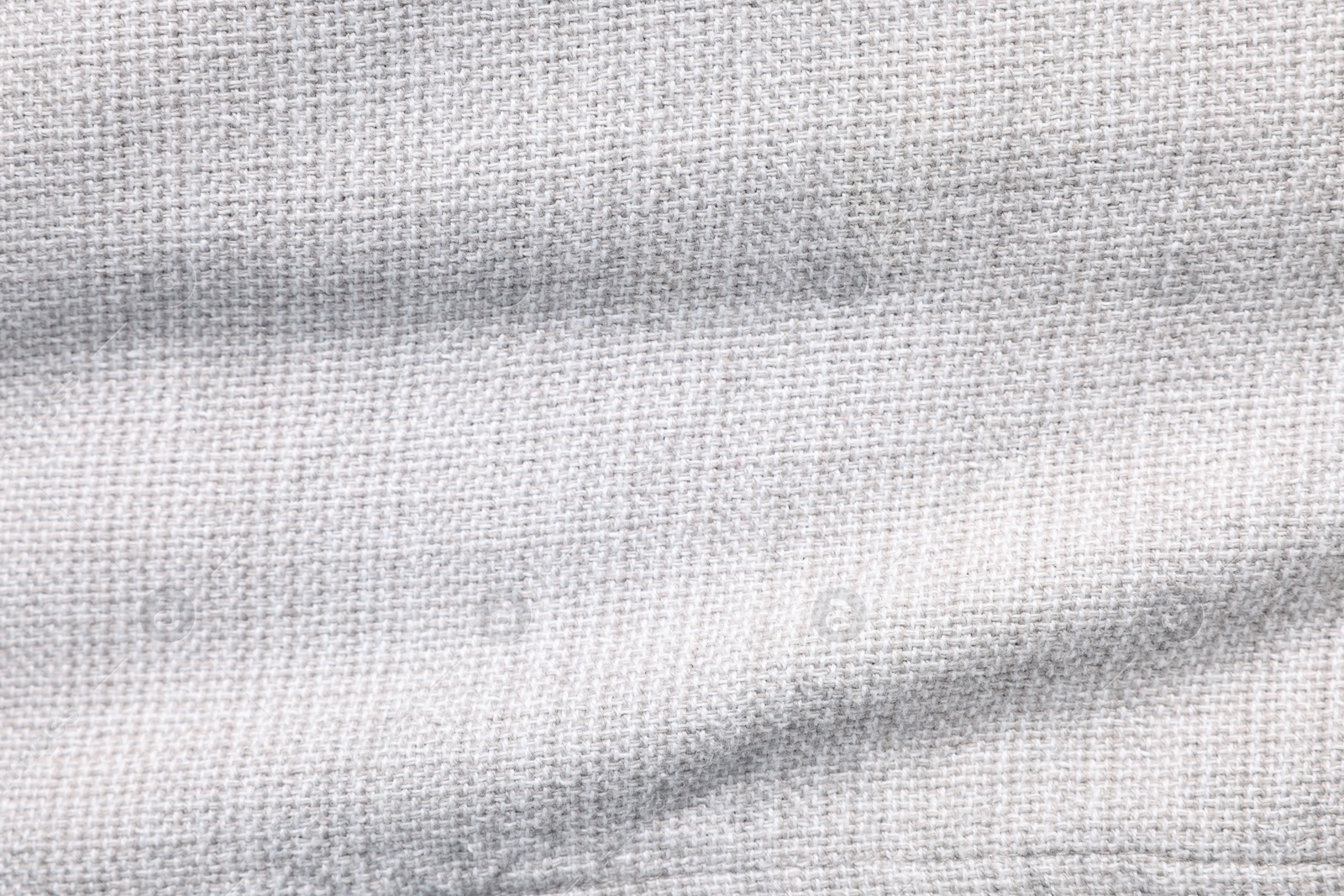 Photo of Texture of white fabric as background, top view