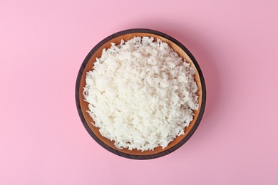 Photo of Bowl of boiled rice on color background, top view