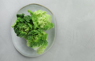 Photo of Fresh ripe Chinese cabbages on light grey table, top view. Space for text