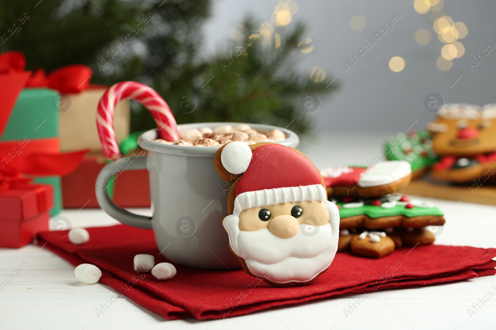 Photo of Tasty homemade Christmas cookie and hot chocolate with marshmallows on white wooden table