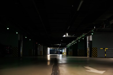 Photo of Dark modern car parking garage at night