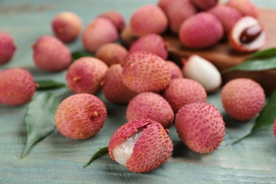 Photo of Fresh ripe lychee fruits on wooden table