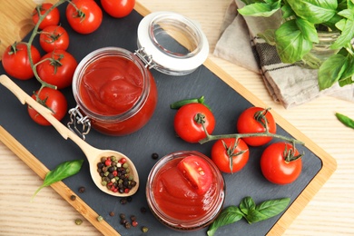 Composition with tasty homemade tomato sauce on wooden table, top view