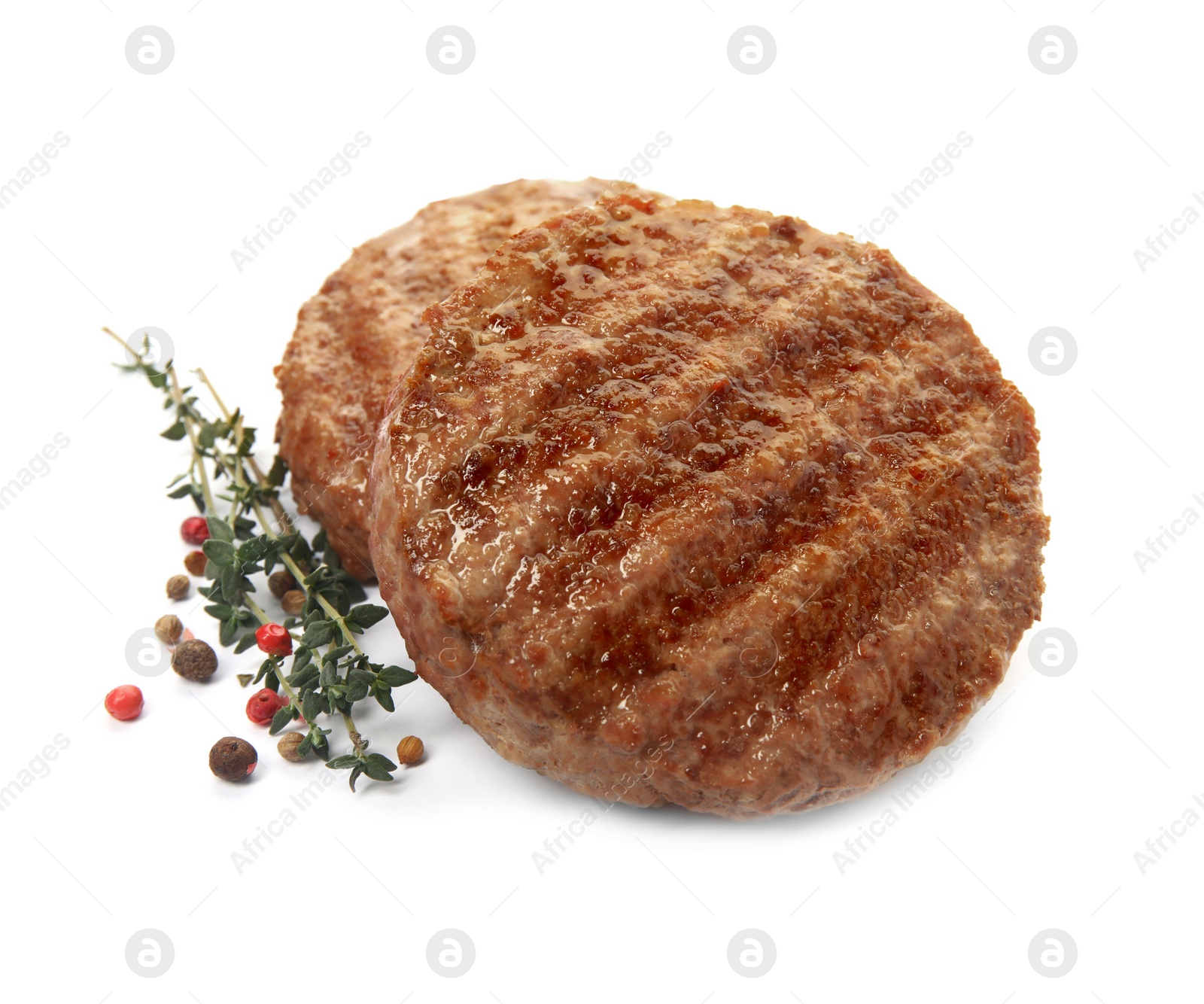 Photo of Tasty grilled hamburger patties with seasonings on white background