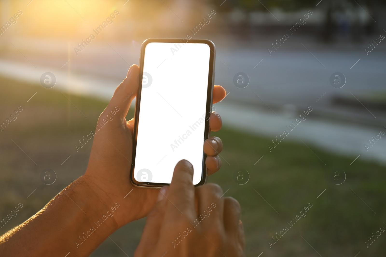 Photo of Man using modern mobile phone outdoors, closeup