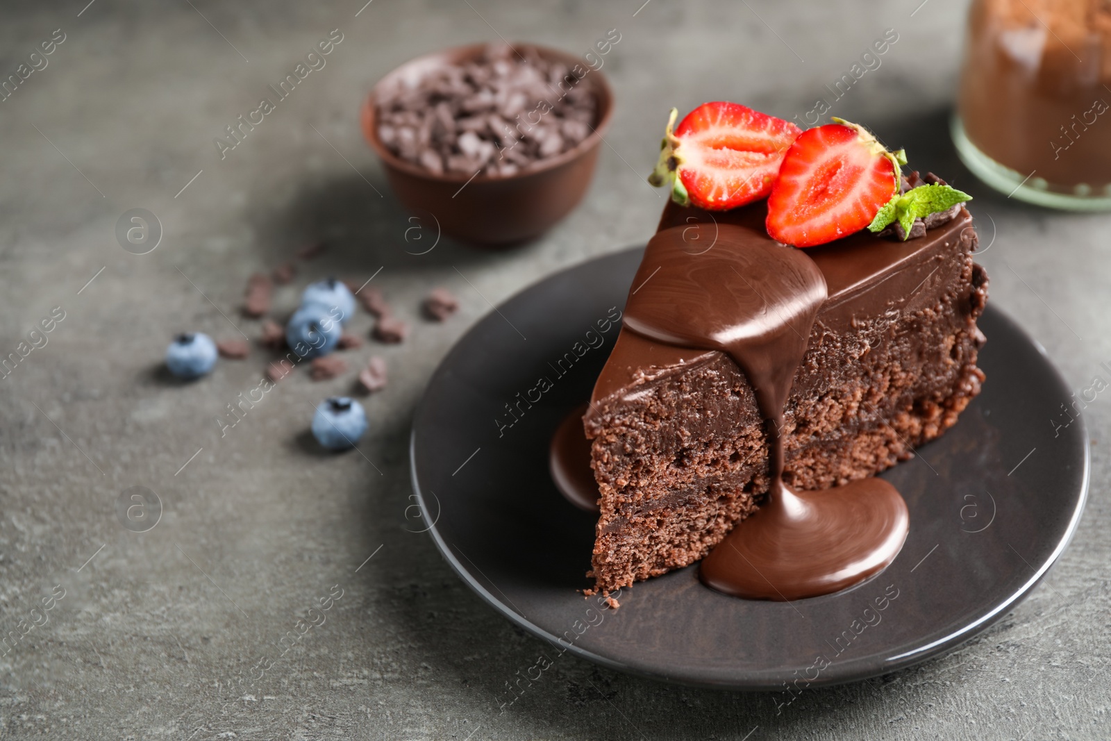 Photo of Delicious fresh chocolate cake with strawberry on grey table