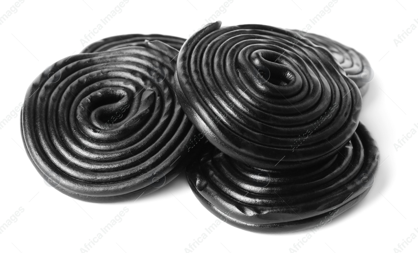 Photo of Tasty black liquorice candies on white background