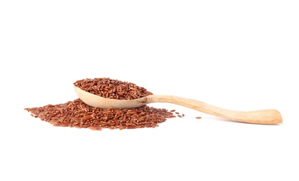 Spoon and uncooked brown rice on white background