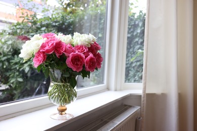 Vase with beautiful bouquet of roses on windowsill indoors, space for text