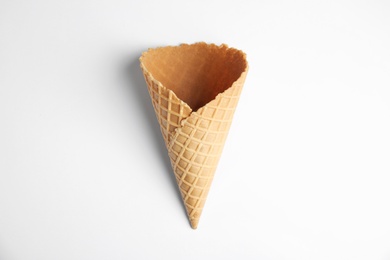 Photo of Empty wafer ice cream cone on white background, top view