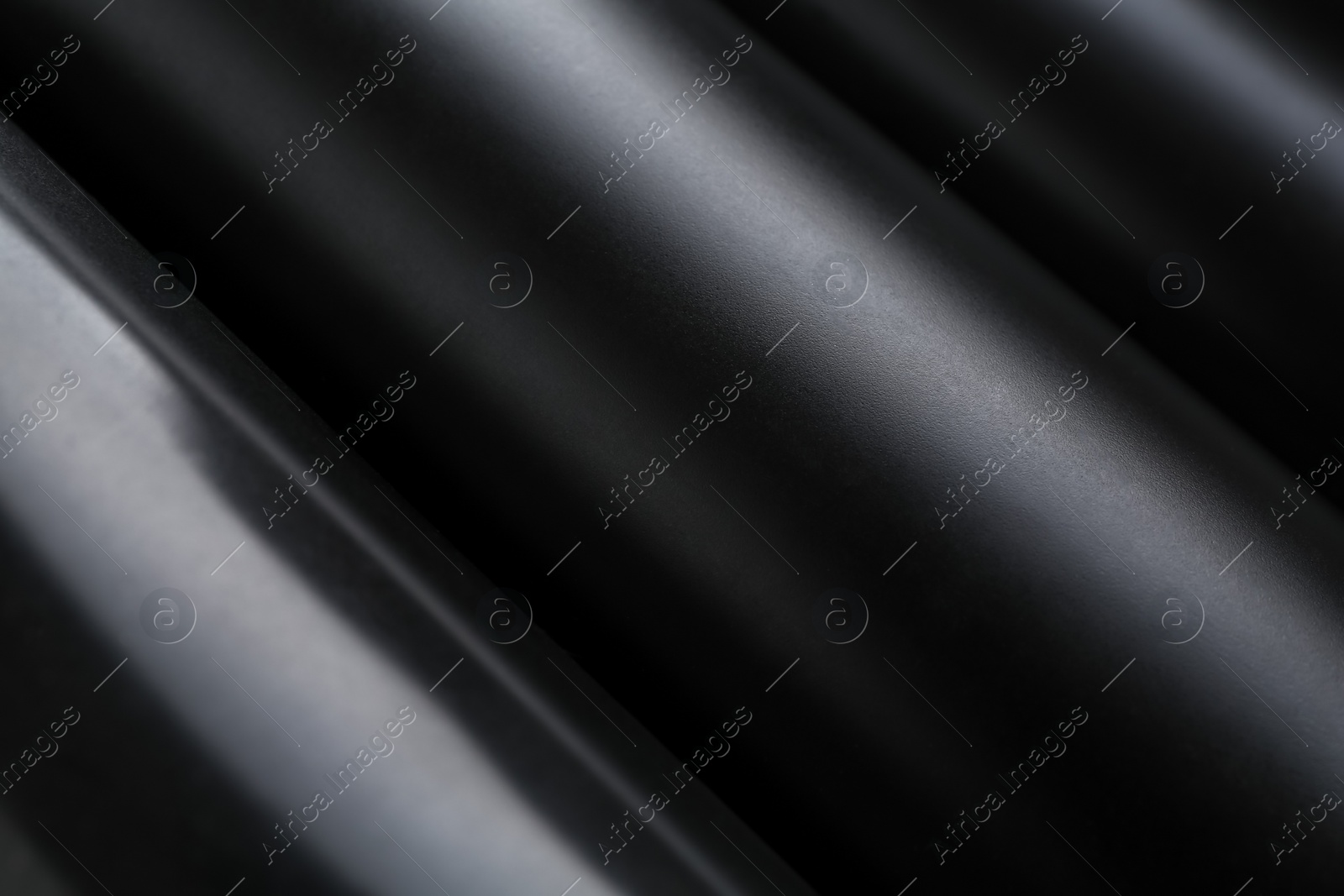 Photo of Energy drinks in black cans as background, closeup
